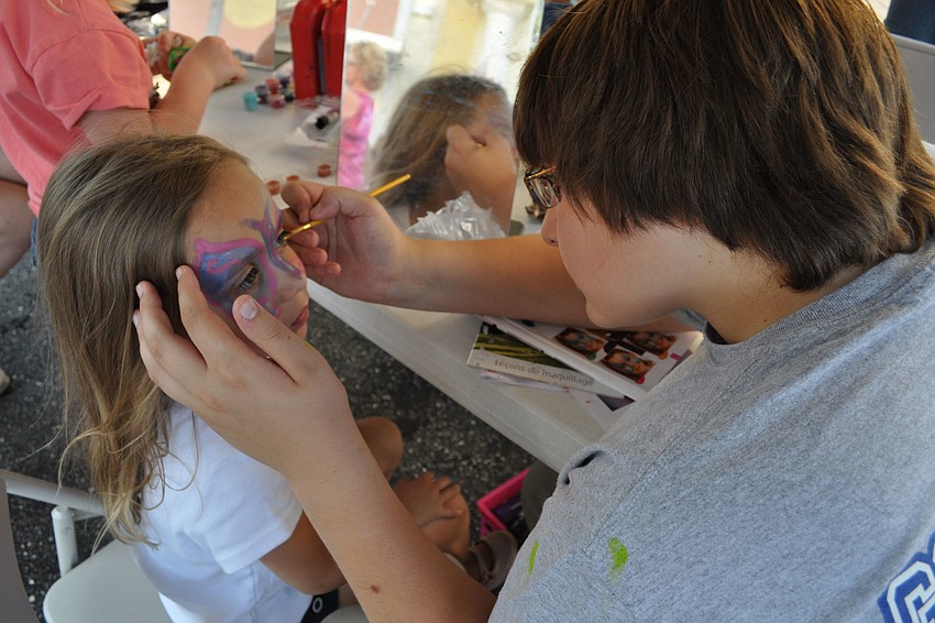 Maya Griffin gets her face painted by Michael Balars.