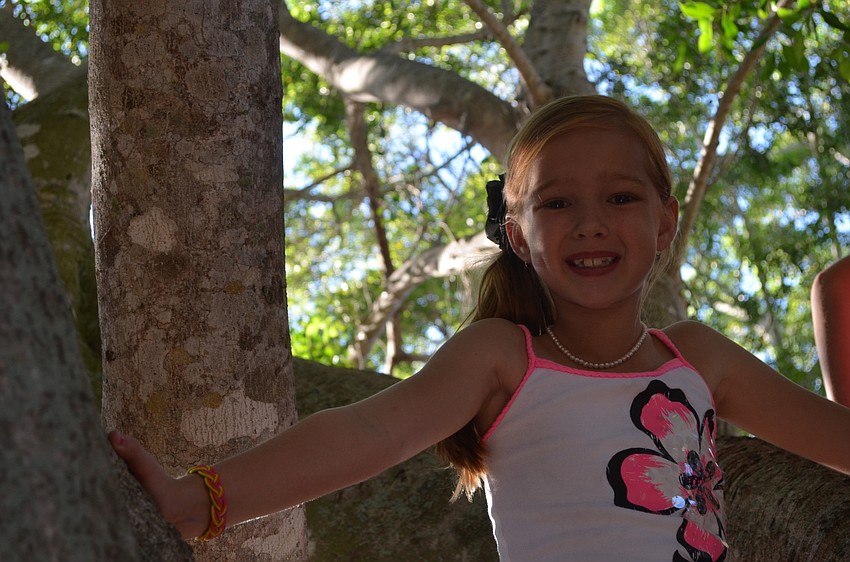 Kendall D. climbs a tree.