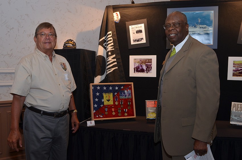 Former USS Pueblo Prisoner of War Rick Rogala and Vice Mayor Willie Shaw look over medals Rogala had received for his service. He was held as a prisoner of war in North Korea for 11 months and finally released on Dec 23, 1968.