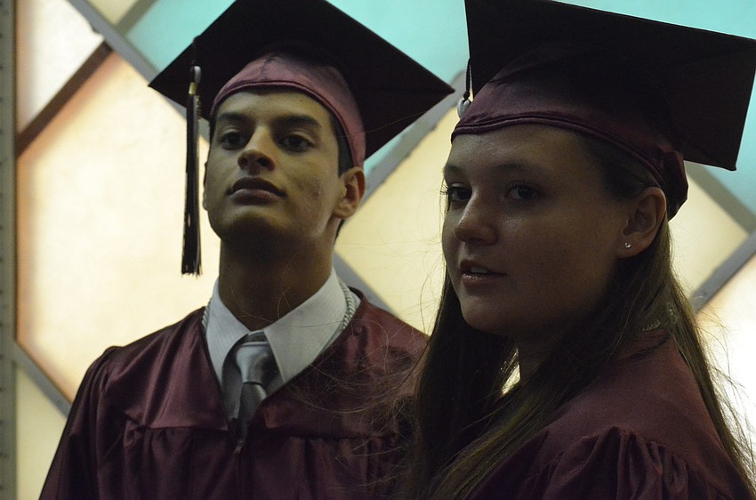 Harold Hernandez and Lindsey Kisielewski cool off by a fan before heading to the arena. Hernandez will study physical therapy at Utah State. Kisielewski will also study physical therapy, but at Florida Gulf Coast University.