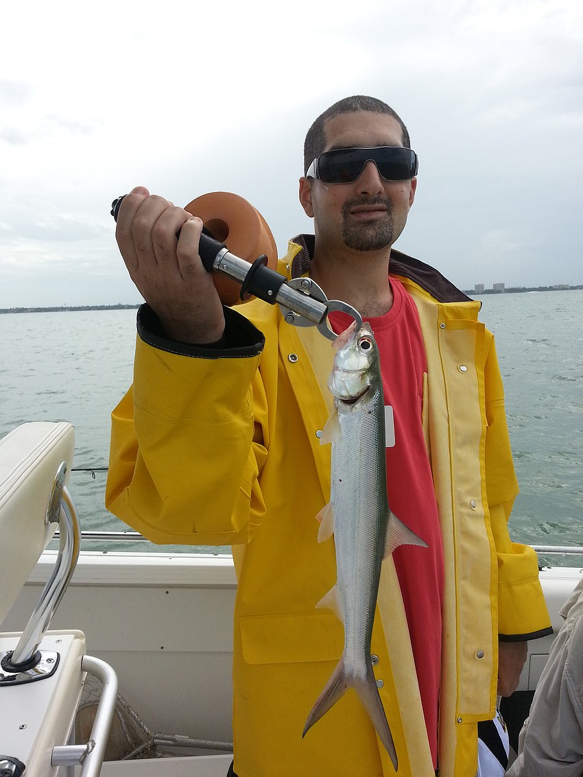 Louis Amico catches a ladyfish on his outing with community volunteers.