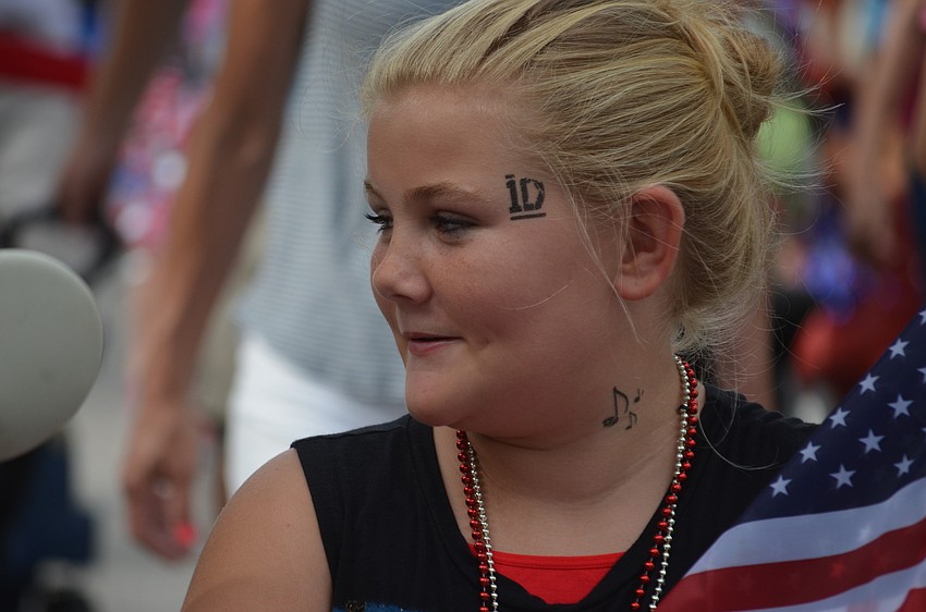 Averie Robinson rides a colorful moped in the parade.