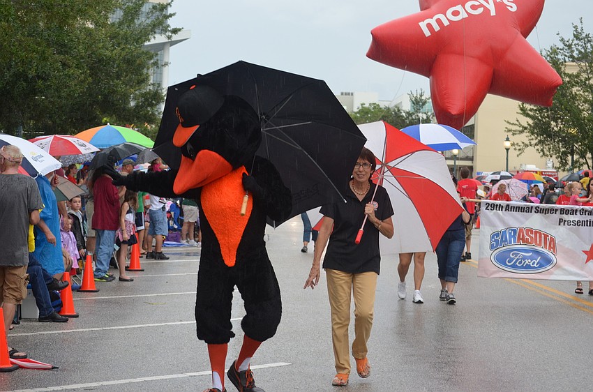 The Orioles Bird carries an umbrella to stay dry.