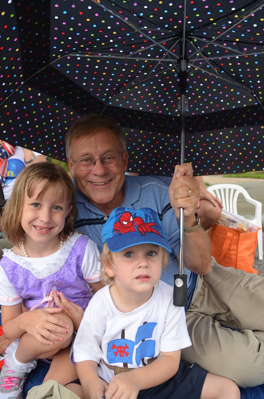 Tasman Henry, 5, and her little brother Kepler with their grandfather John Childers