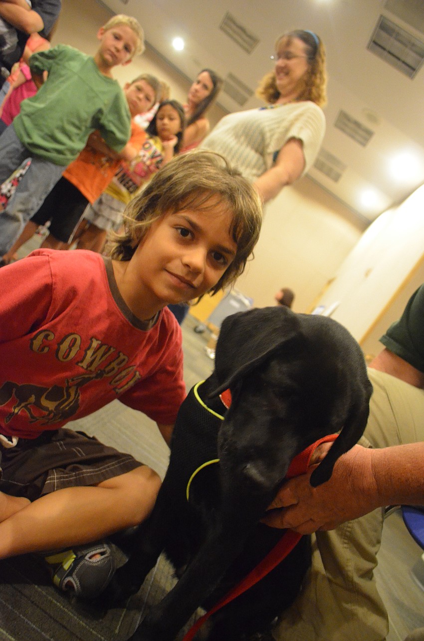 Jon-Luc Volpe, 8, pets black lab Kaleb.