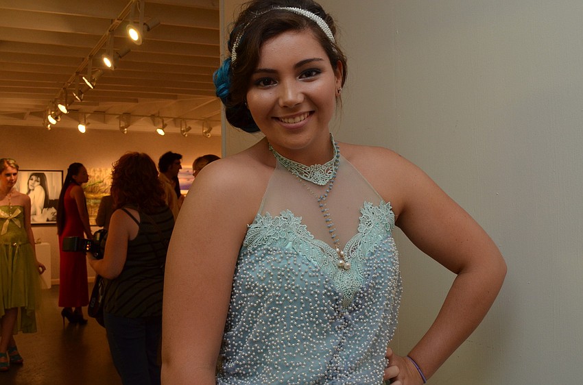 Sarina Swalm poses in a dress designed by Raven Peters. This dress won first place.