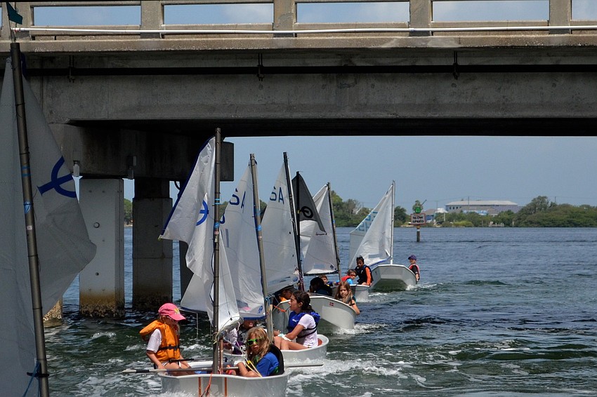 The 7-boat tail line gets pulled under the Coon Key Waterway bridge.