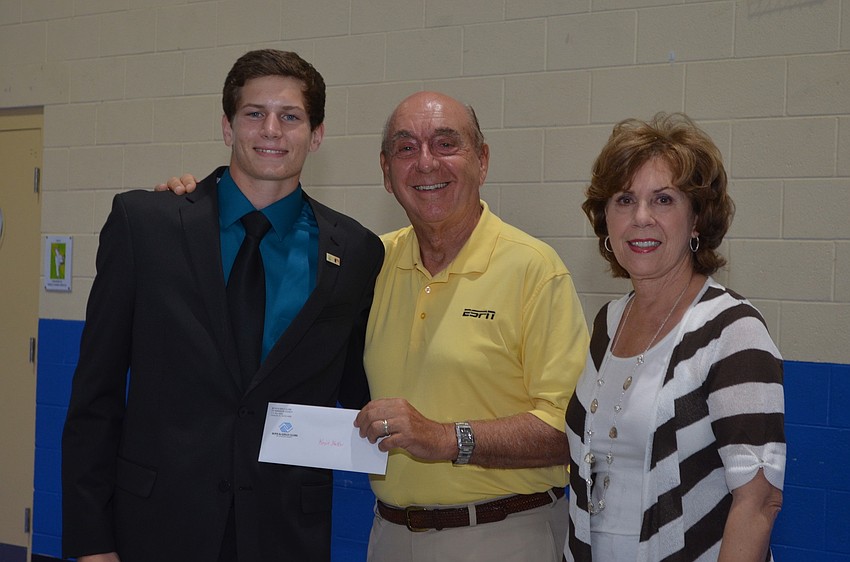 Dick and Lorraine Vitale present Riverview High School graduate Kevin Stalker with a $1,000 scholarship.
