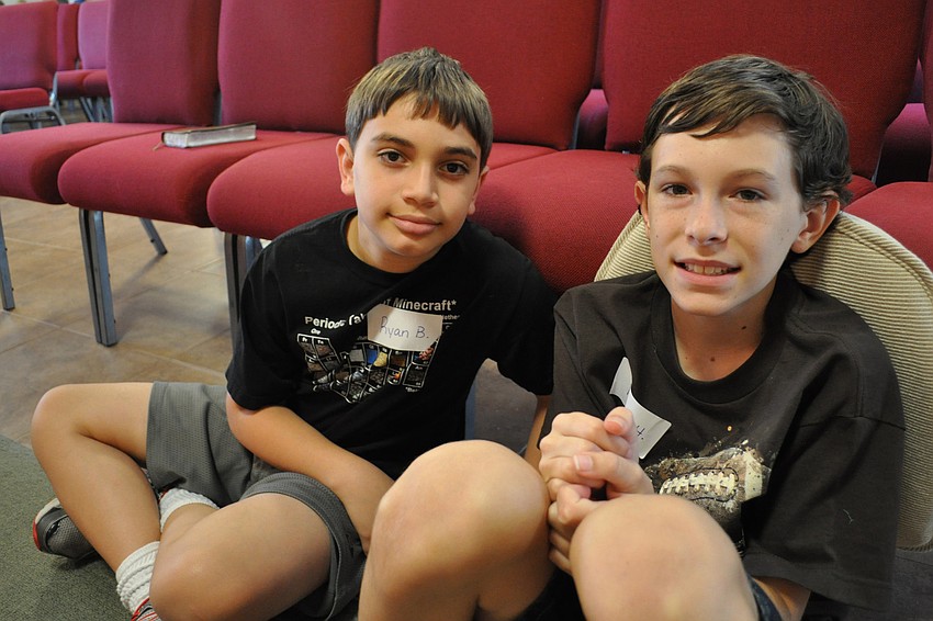 Ryan Barbanera and Ryan Hillock listen to Bible stories.