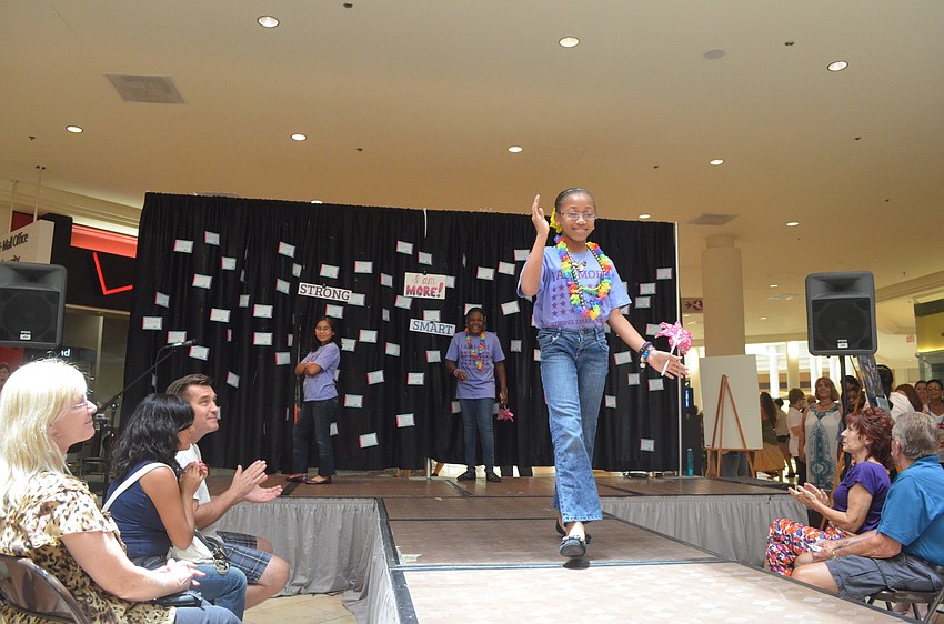Shaniya Lane waves to the crowd as she displays confidence.
