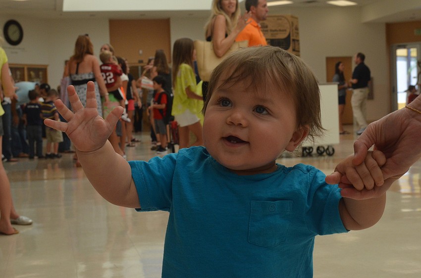 One-year old Cooper walks around while his brother Matthew Fasold prepares for school.