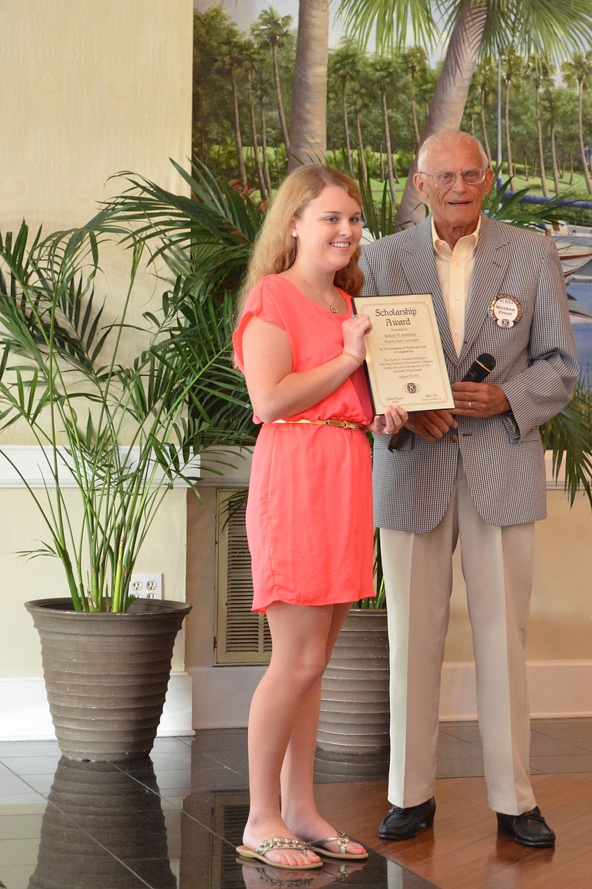 FSU student Kelsey Anthofer accepts her scholarship certificate from Weldon Frost.