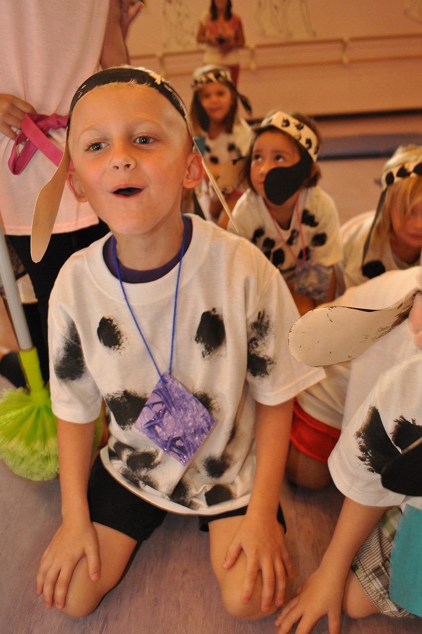 Landyn Camus barks as the puppies celebrate being found.