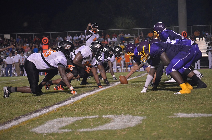 Players face off at the line of scrimmage.