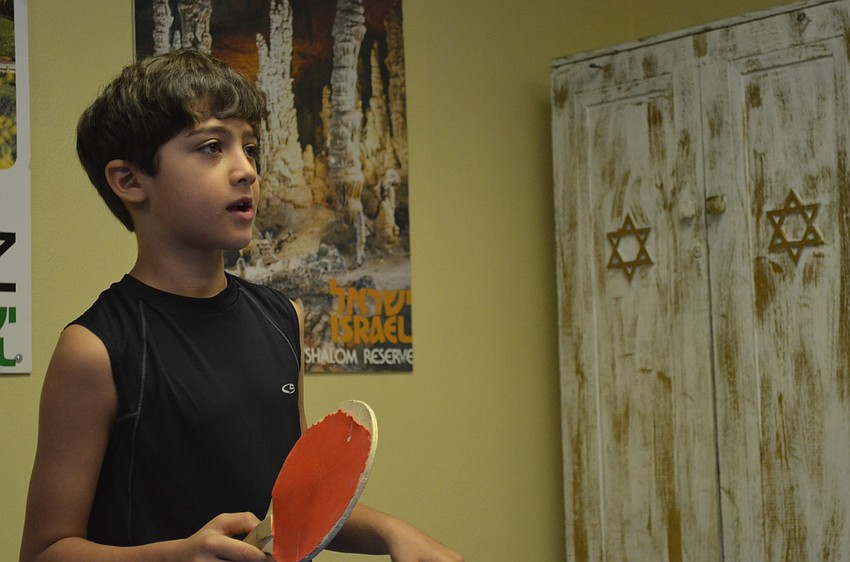 Jonah Seldin Schneider, 9, plays ping-pong with his brother Eitan, 12.