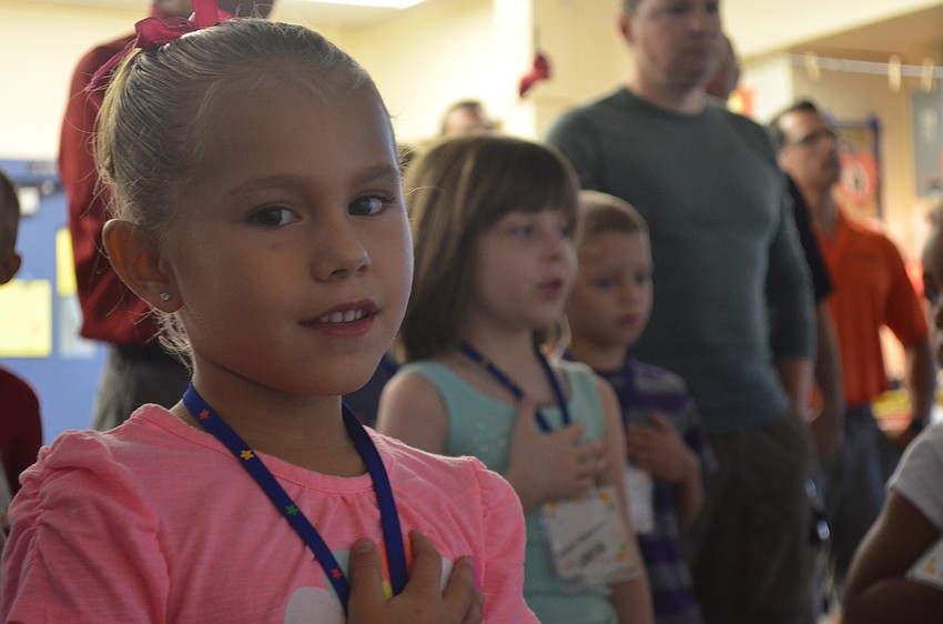 Kindergartner Kirsten Soler says the Pledge of Allegiance during morning announcements.