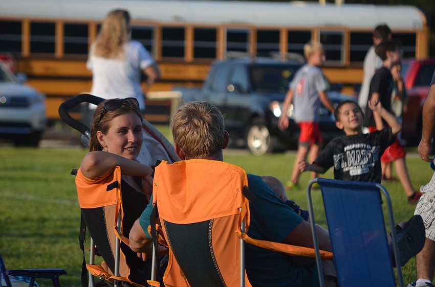 Jenna and Corey McCoy enjoy the evening with each other and their children.