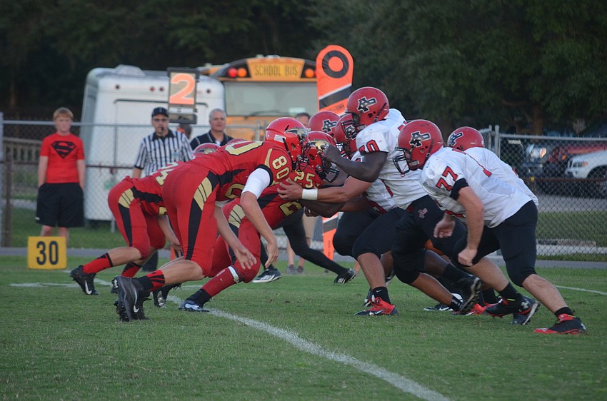 Matt Hueston lunges forward against his opponents as the play begins.