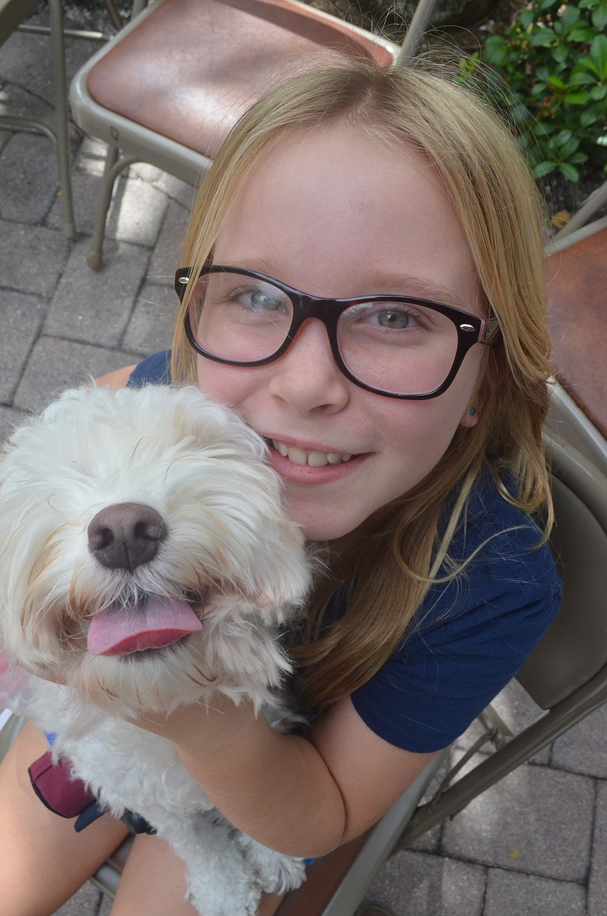 Caelin Gorman, 9, and her 2 â€“ year old cockapoo Pretzel