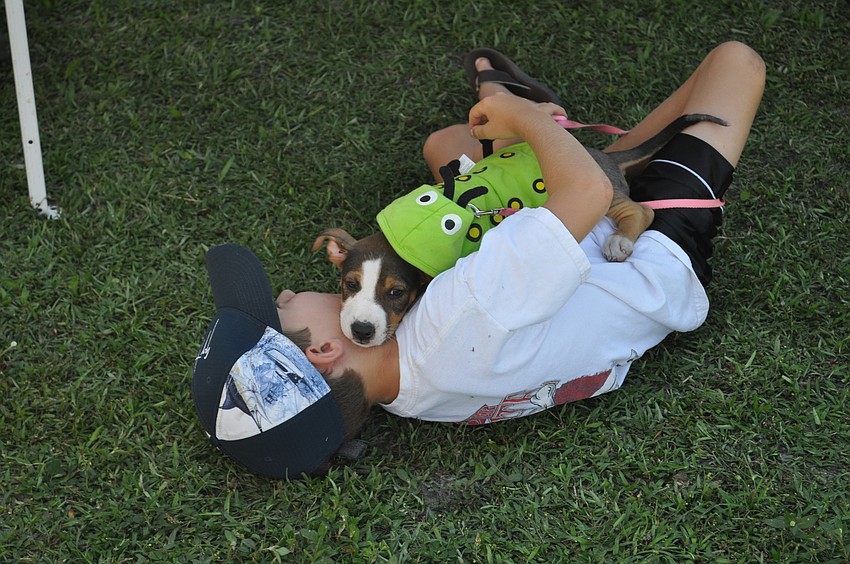 Paul Hovey cuddles with a puppy