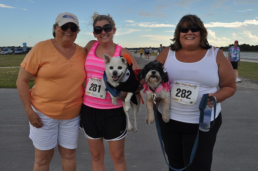 Clare Loer with Kelsey and Kim Sprague dressed up their dogs Cali and Lucky
