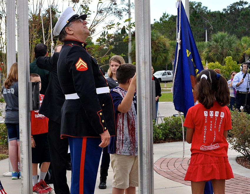 U.S. Marine Corps veteran Rick Johnson admires the flags raised during the ceremony.