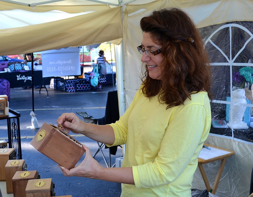 Leslie Armstrong checks out a fellow vendor's product.