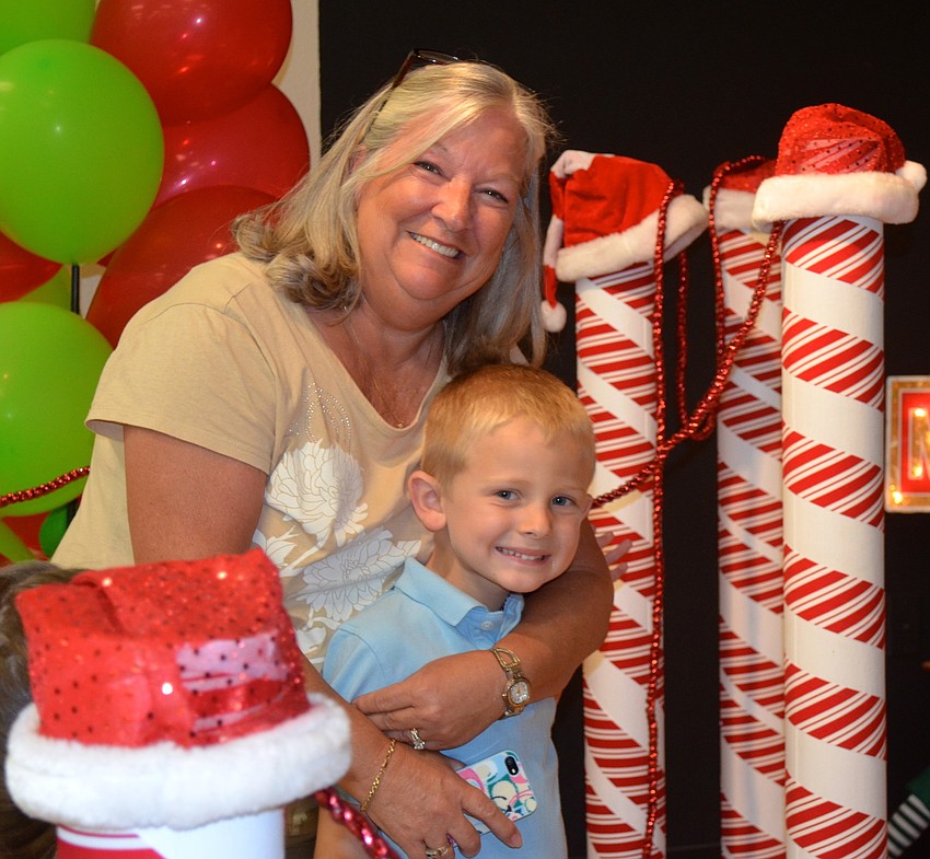 Sandy Swanson waits in line with grandson Timmy Swason, 5.
