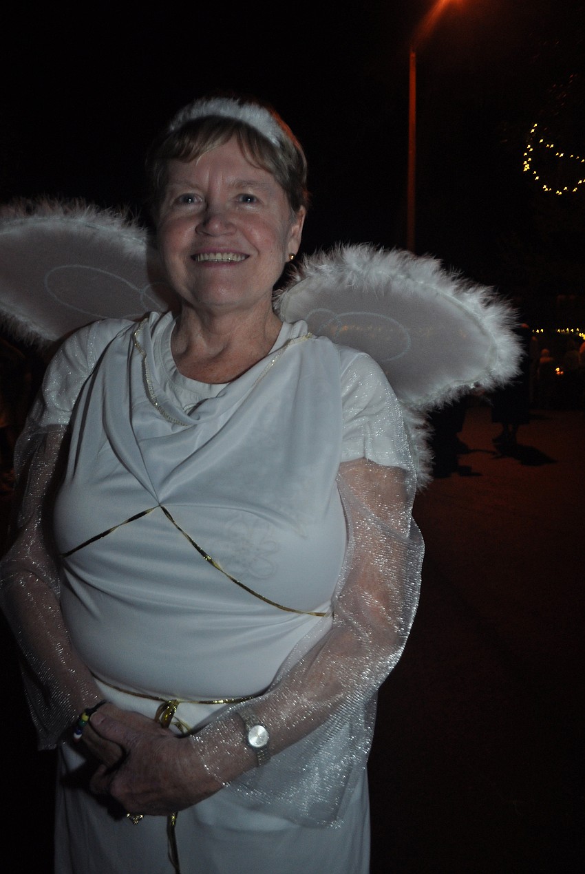 Judy Reinoehl, an angel, spreads the word about Christ's birth.