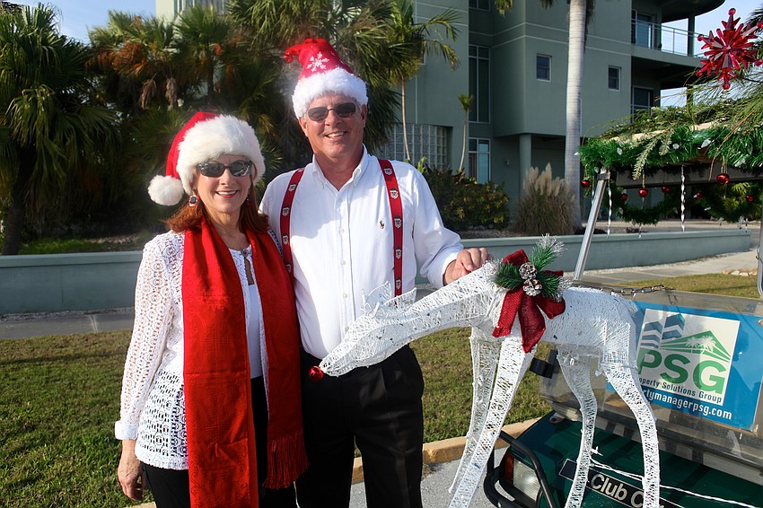 Amy and Michael Drake with their decorated golf cart, which won first prize.
