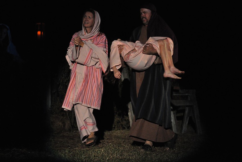 Clint and Alissa Urban carry Angel Potter to be healed by Jesus.