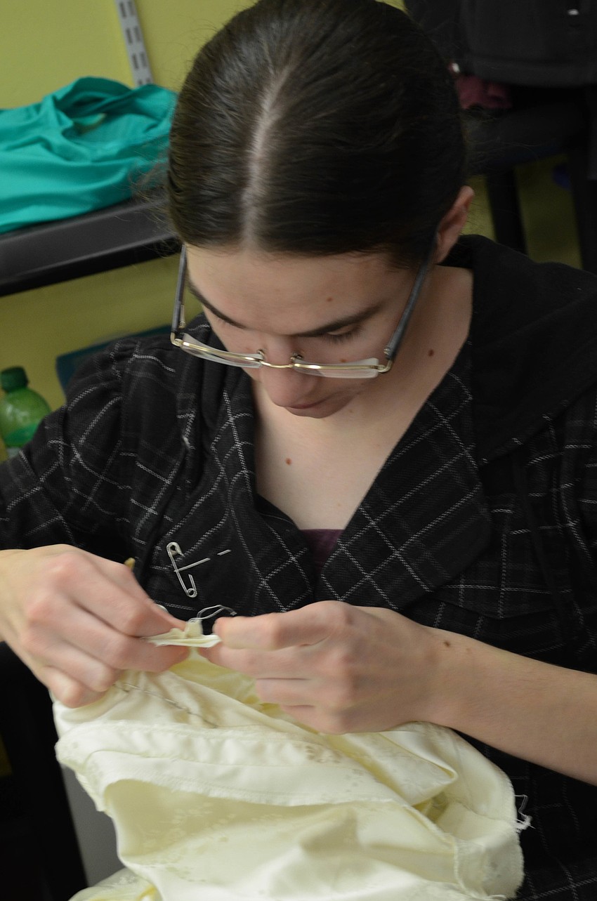 Sarah Pipho sews a nightgown
