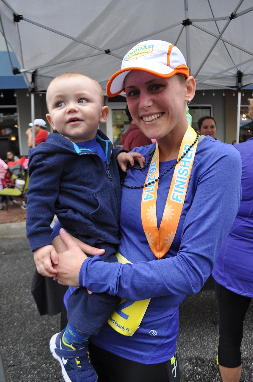 Jennifer Hargaden holds her son Aeden, 1, after the race.