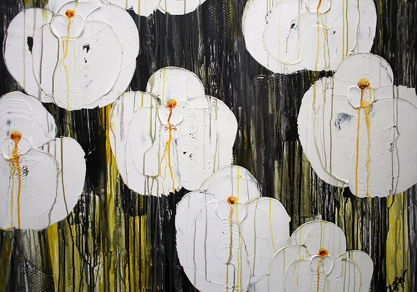 â€œMoon Orchids with Yellow,â€ a painting by Diane Dean, hangs in her booth at the art festival.