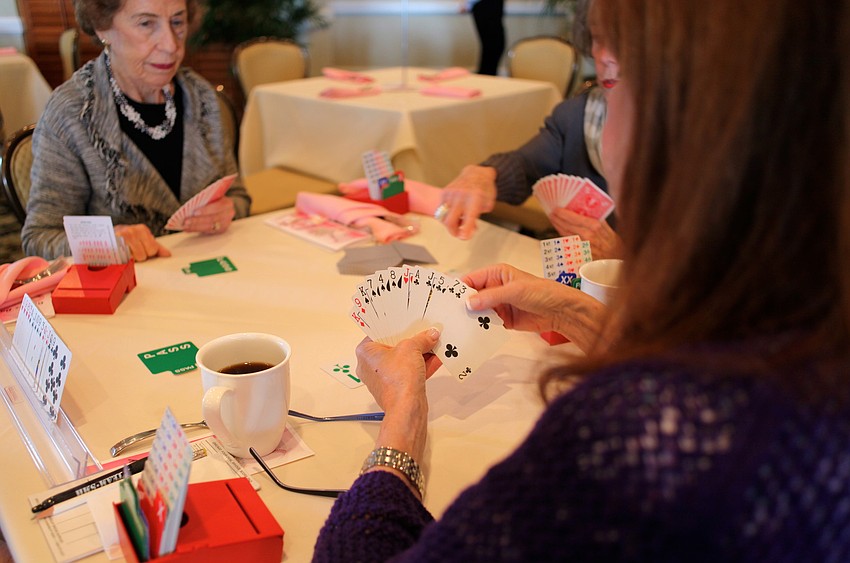 Betty Levi waits for Sandy Silverbergâ€™s play in their game of bridge.