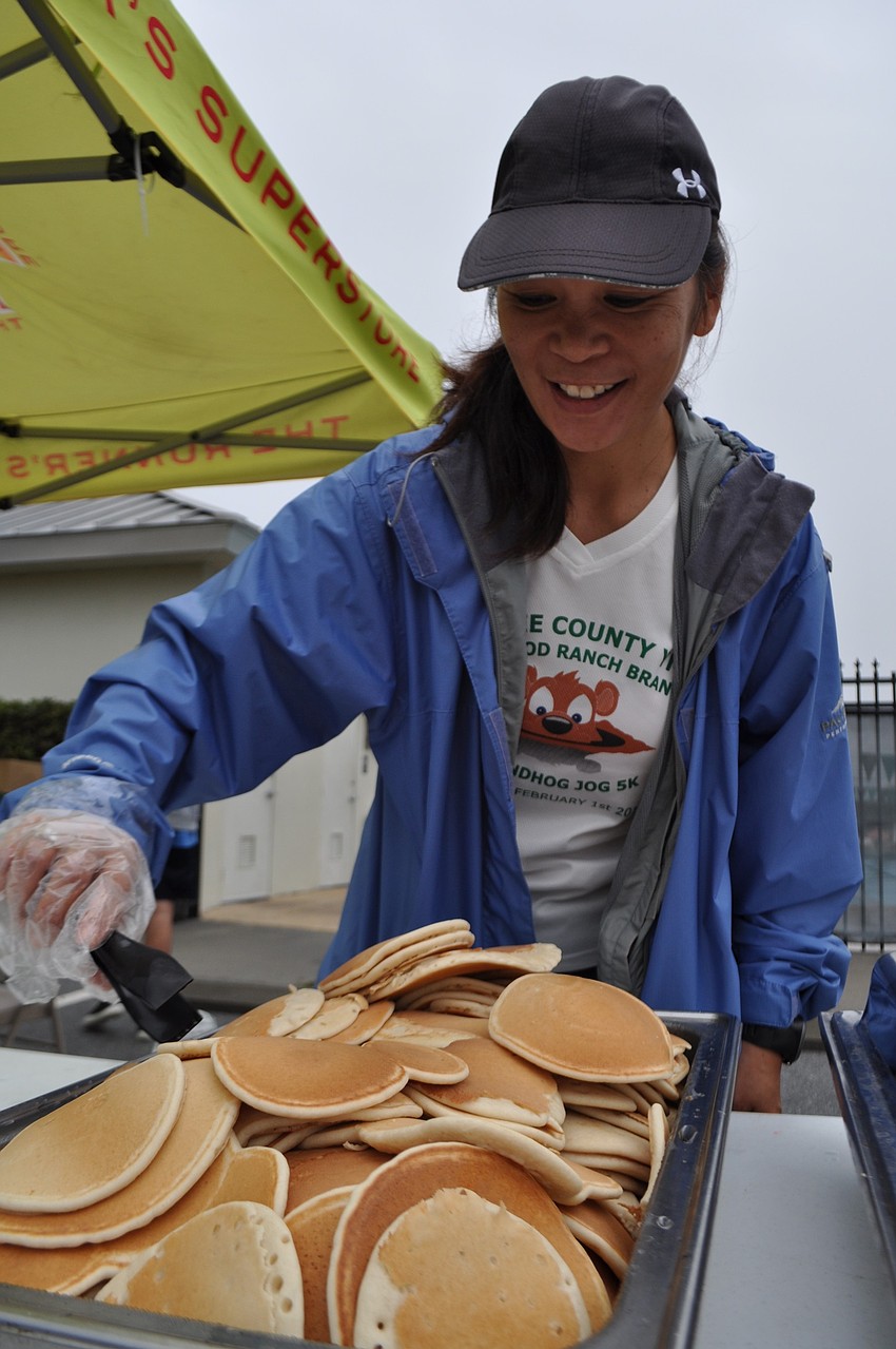 Cheryl Bourque dishes out pancakes.