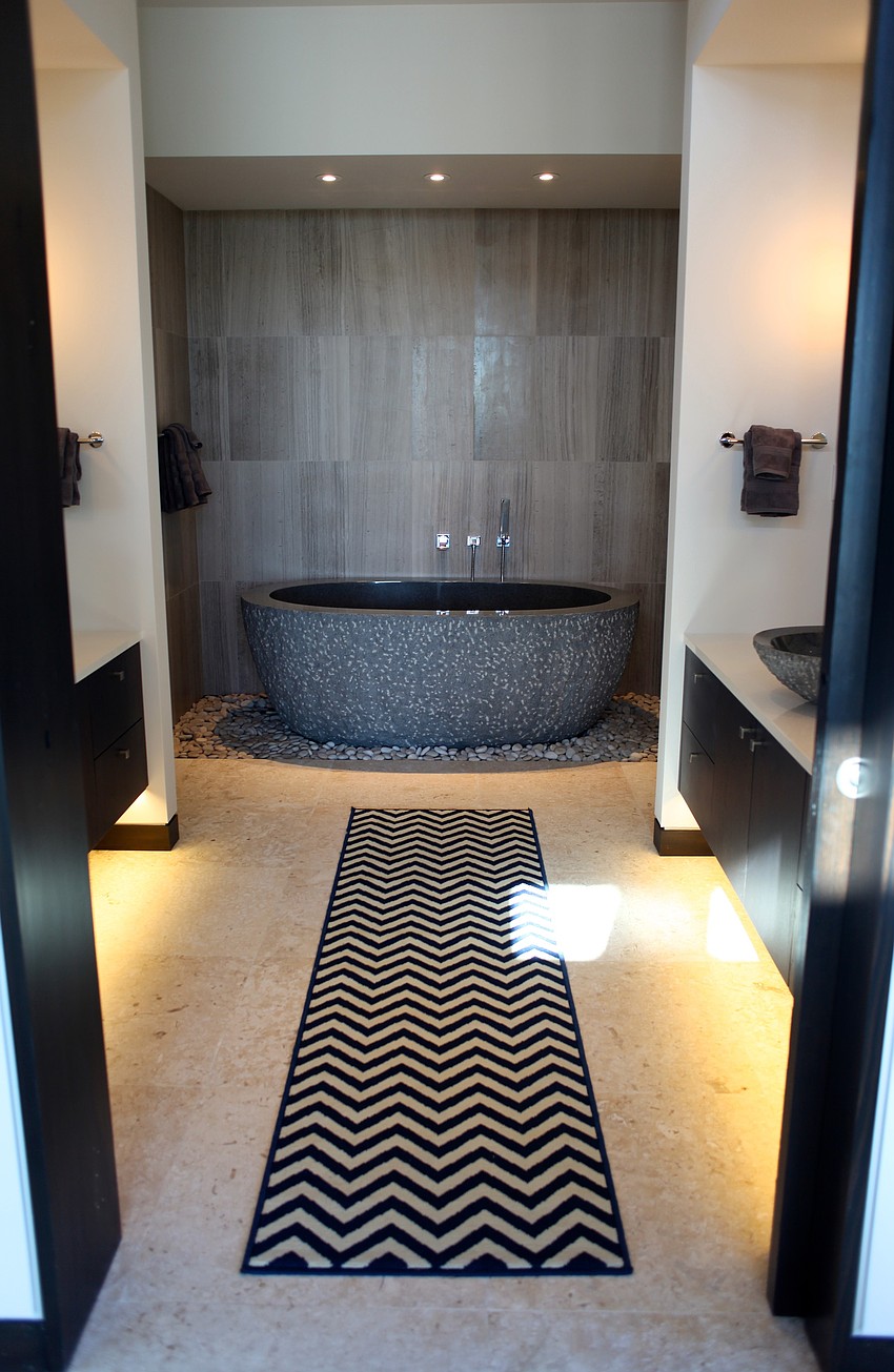 A spacious bathtub is the focus in the guest bathroom.