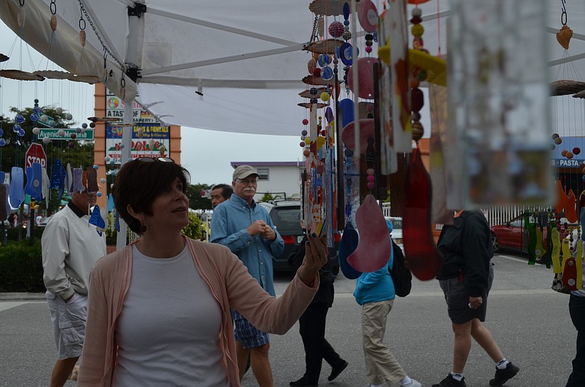 Barrie Sokmensuer browses glass wind chimes.
