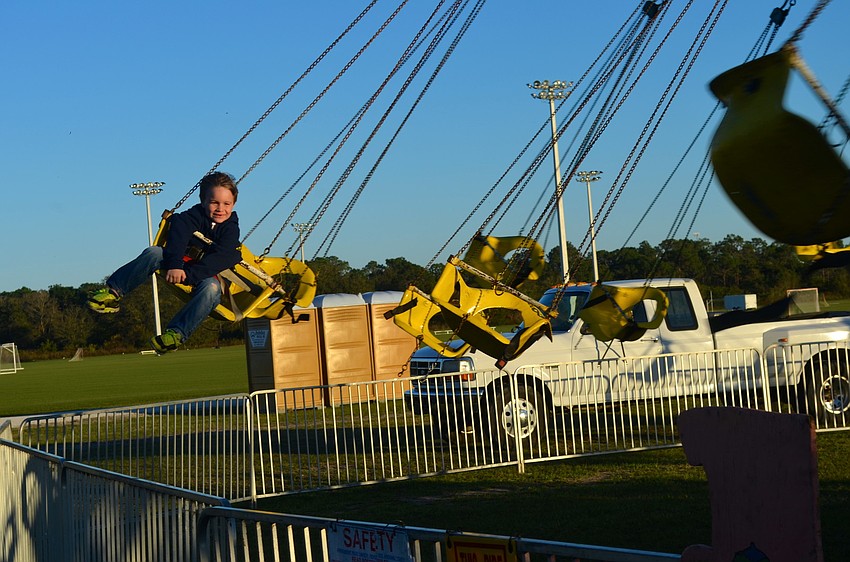 Cooper Leiberick, 5, mans the swing ride alone.