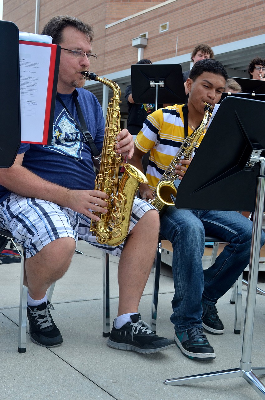 BRHS Band Director Kendall Carrier plays alongside Victor Vargas, 16.