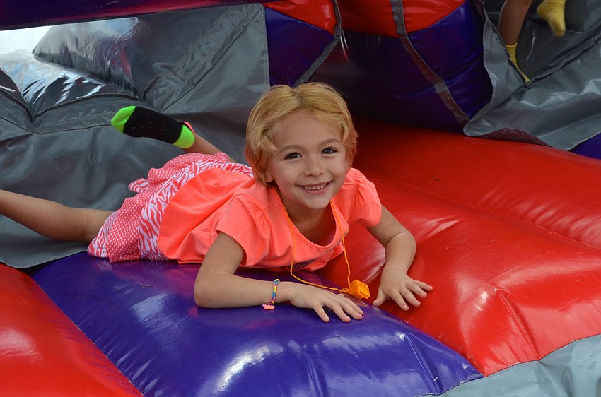 Aliyah Rozanski, 6, rests after racing through the obstacle course.