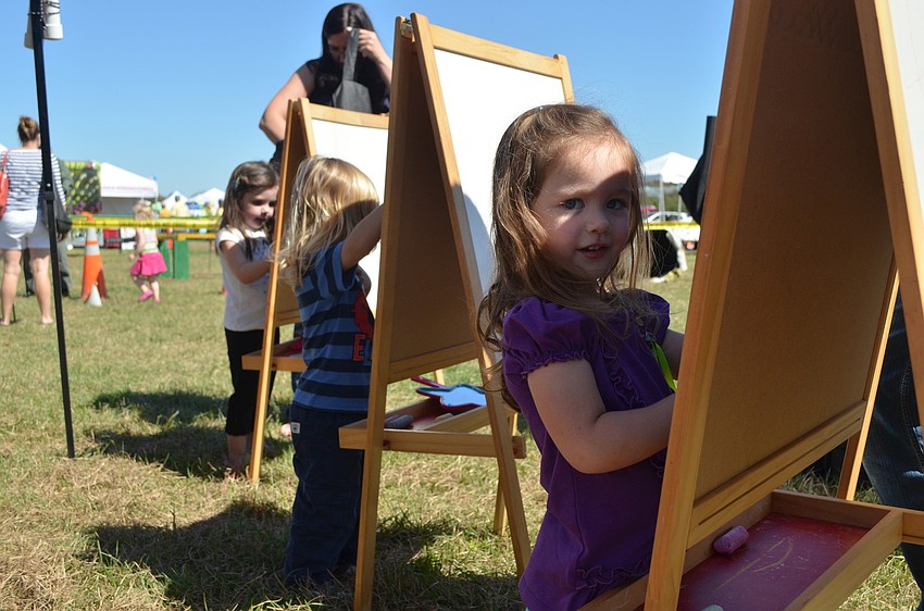 Scarlett Gratton plays with chalk.