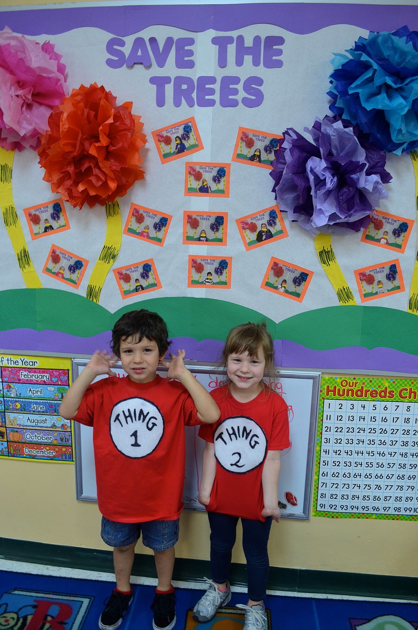 Five-year-old twins Daniel and Camilla Correa stand by a display themed after Seuss' 
