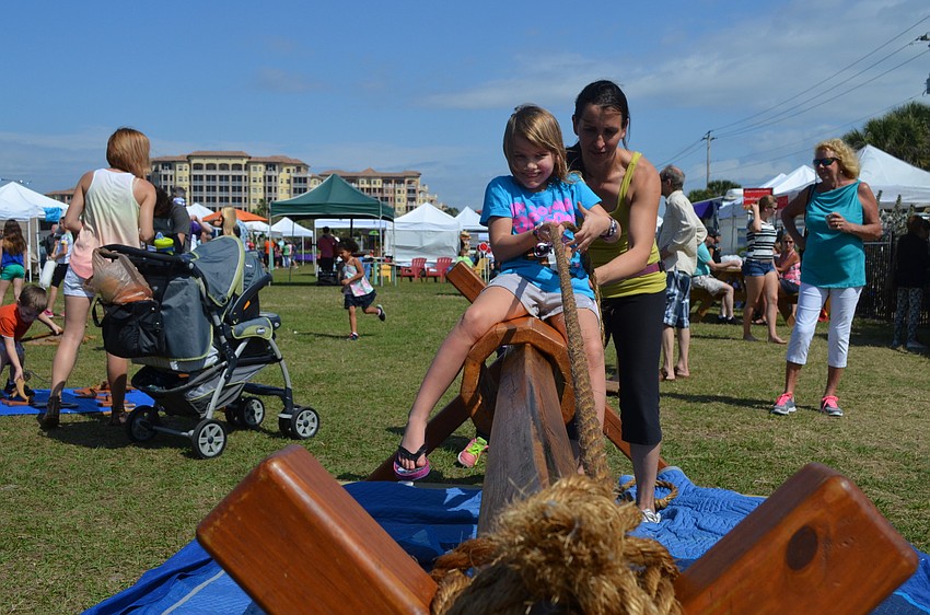 Krisztina Ihaszy helps Kyla Graham pull herself.