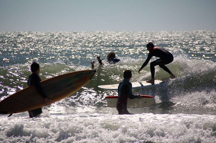 Surfers at Lido Beach.