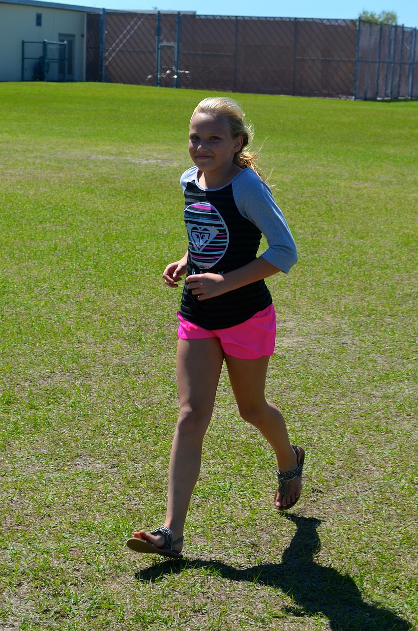Emmi Mathis, 9, walks her final lap.