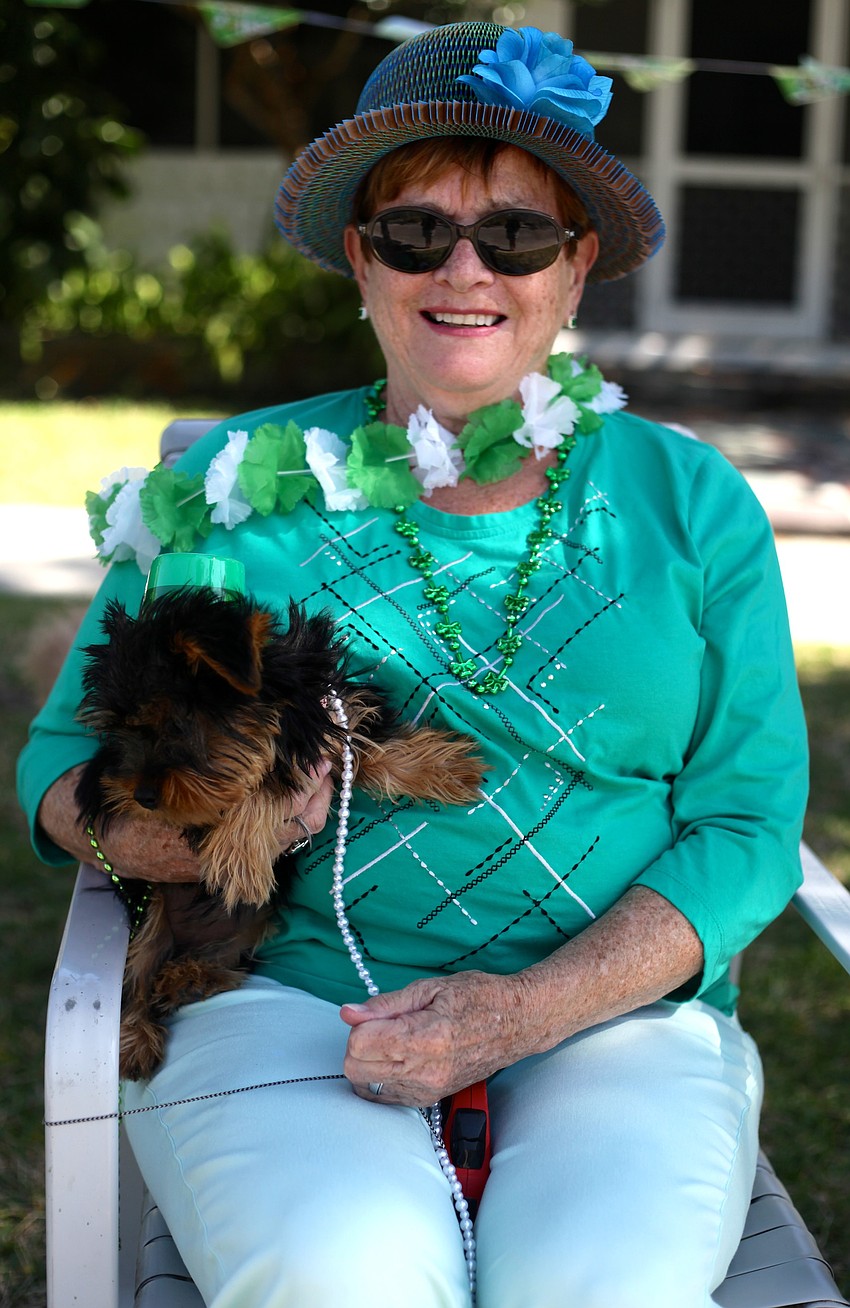 Lynn Rookes and her new puppy, Tula, watch the parade.
