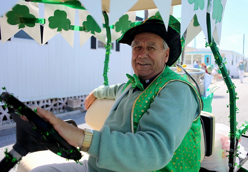 Buck Wendt drives the green beer cart during the parade.