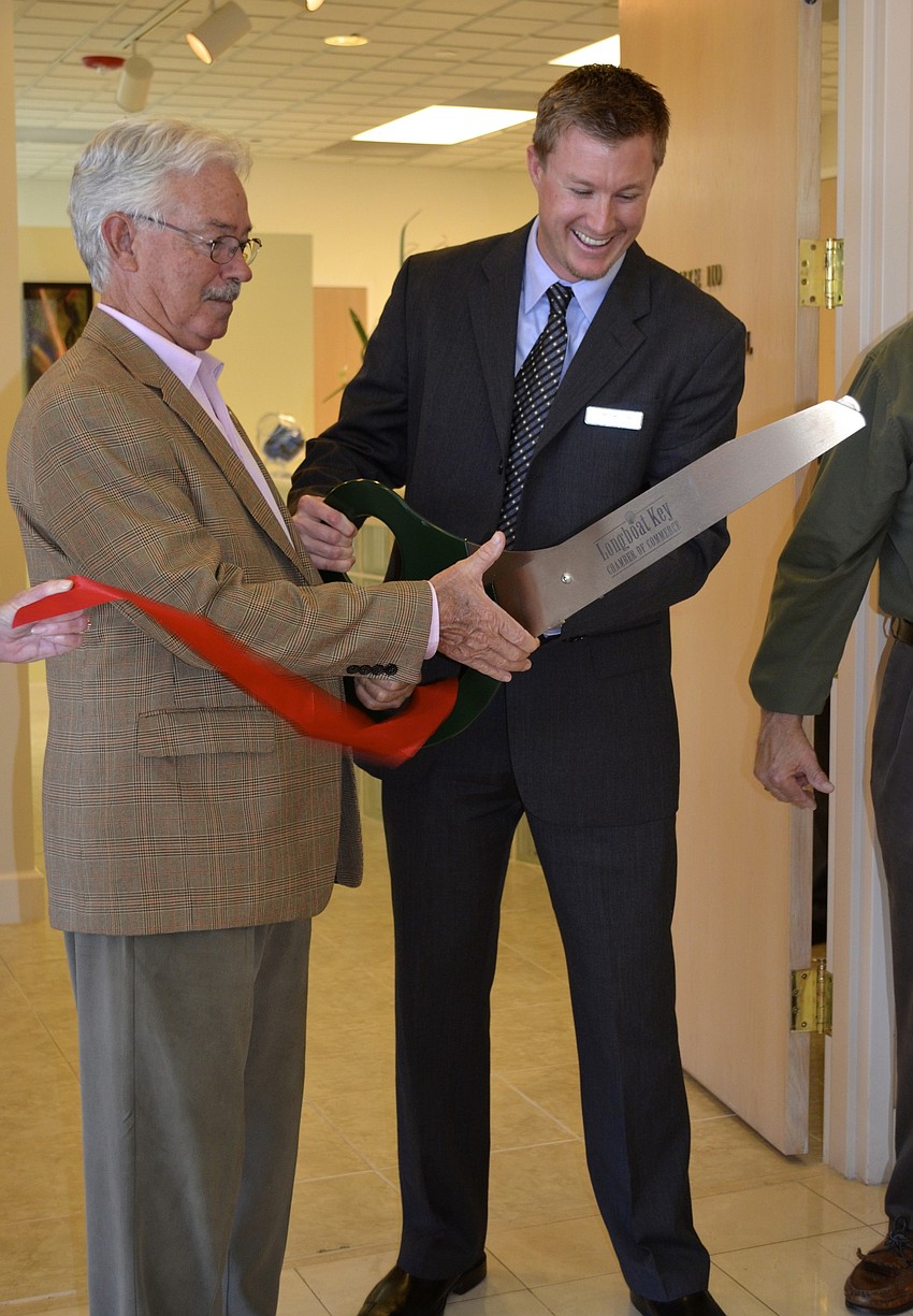 Mayor Jim Brown helps Dr. Michael Oâ€™Neil cut the tricky ribbon.