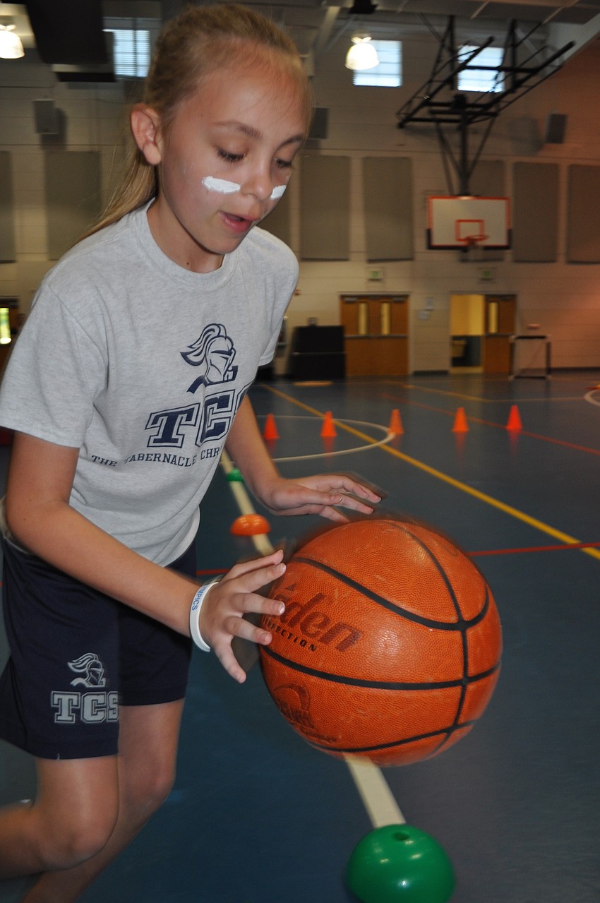 Mary Kate Nolan, 12, dribbles the basketball during the obstacle course event.